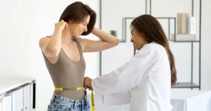 A woman measuring her waistline as part of a Weight Loss Program in Meridian, ID